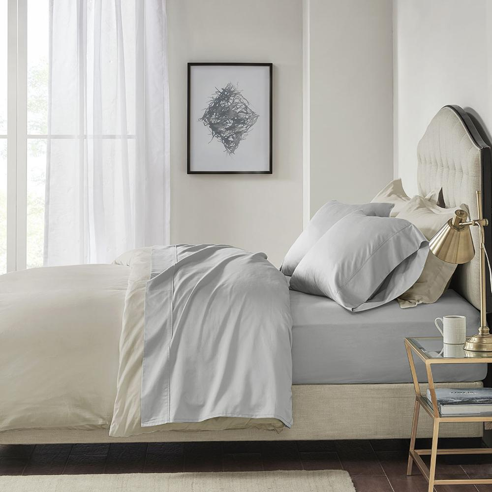 Start2Finish Pima cotton sheet set with smooth, white bedding and neatly folded sheets and pillowcases on a bed.