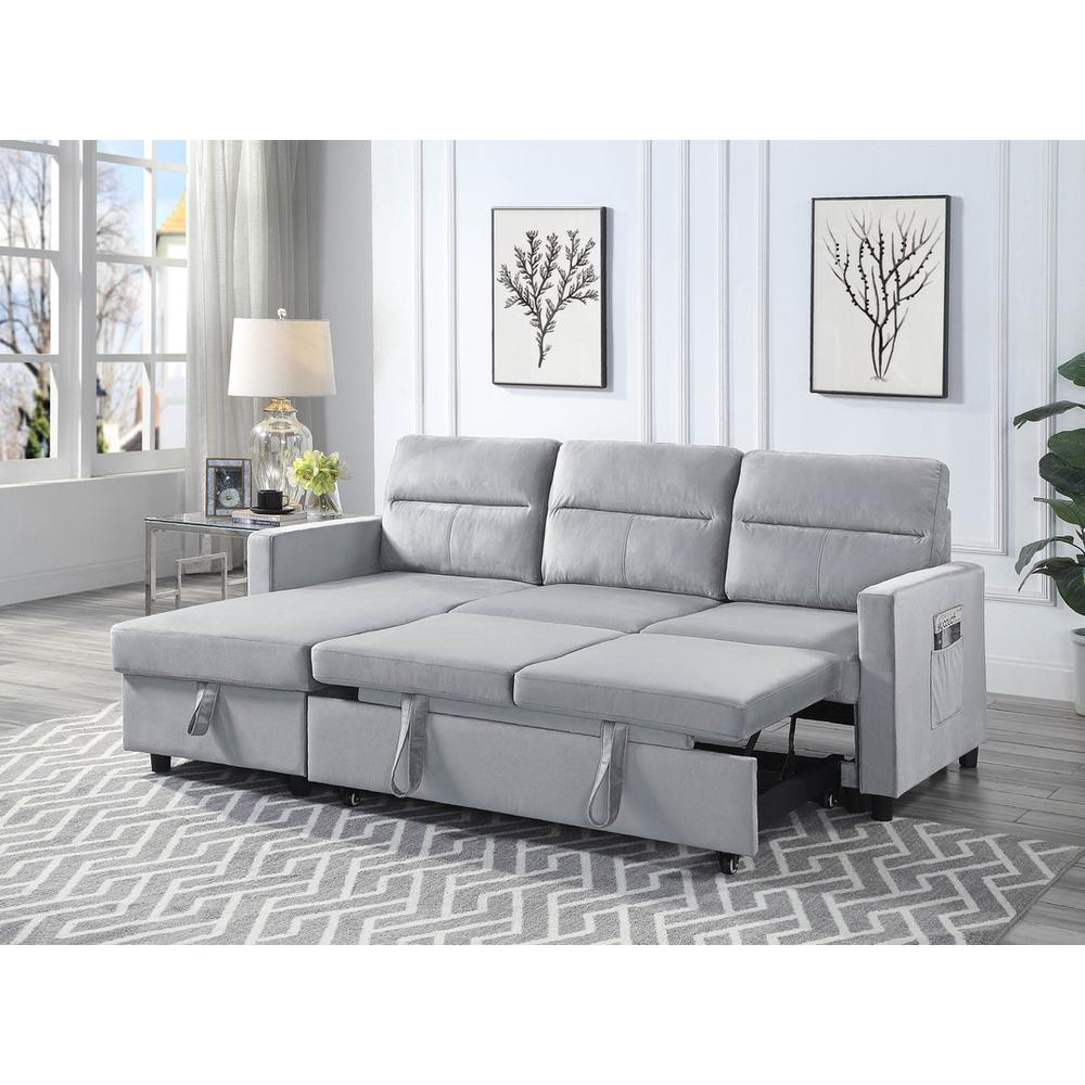 Light gray velvet reversible sleeper sectional sofa with storage chaise and side pocket, featuring plush cushions and modern design.