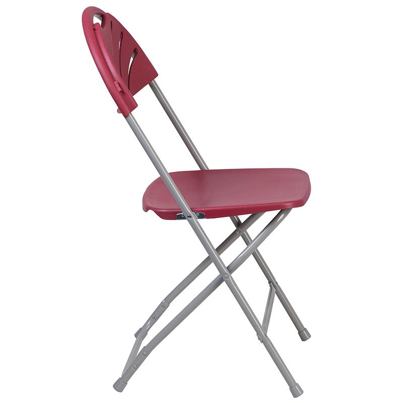 Two burgundy plastic HERCULES Series folding chairs with fan back design, 650 lb. capacity, stacked for easy storage.