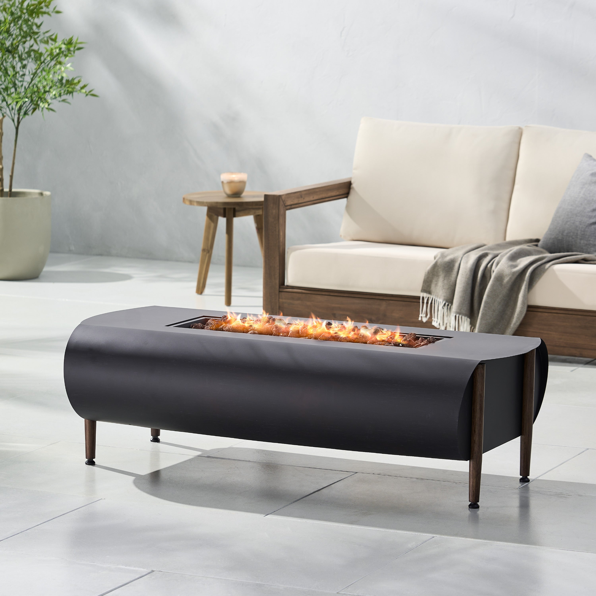 Dark gray iron fire pit table with tank holder, outdoor patio furniture for cozy outdoor living spaces.