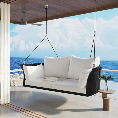 Black wicker hanging rattan porch swing for two, designed for garden use by Carmine Juneberry.