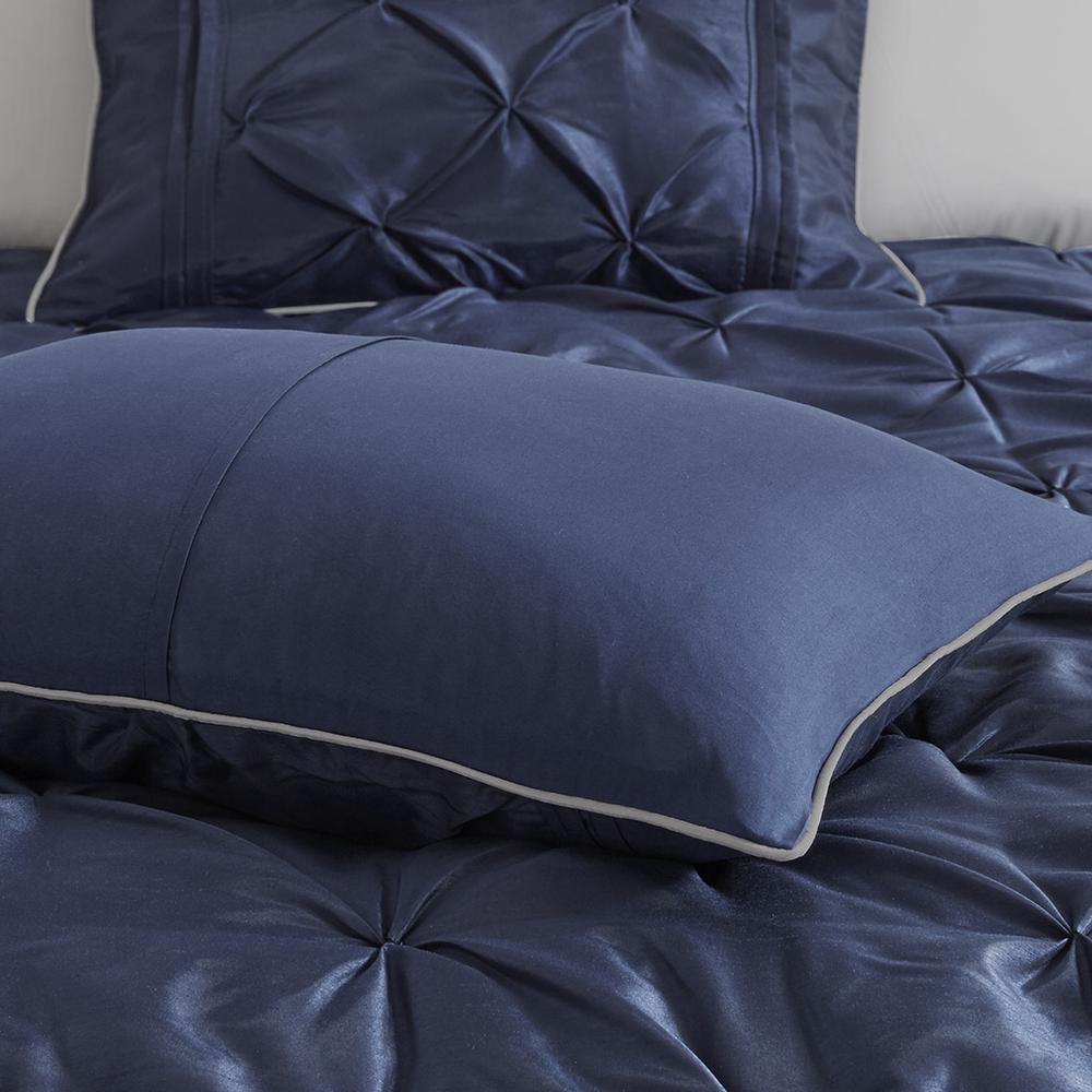 Start2Finish Laurel 7-piece navy tufted comforter set with matching pillow shams and decorative pillows on a bed.