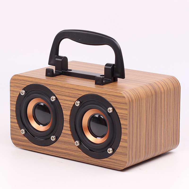 Maroon Asteria portable wooden wireless Bluetooth speaker for outdoor use, showing the compact design on a wooden surface.