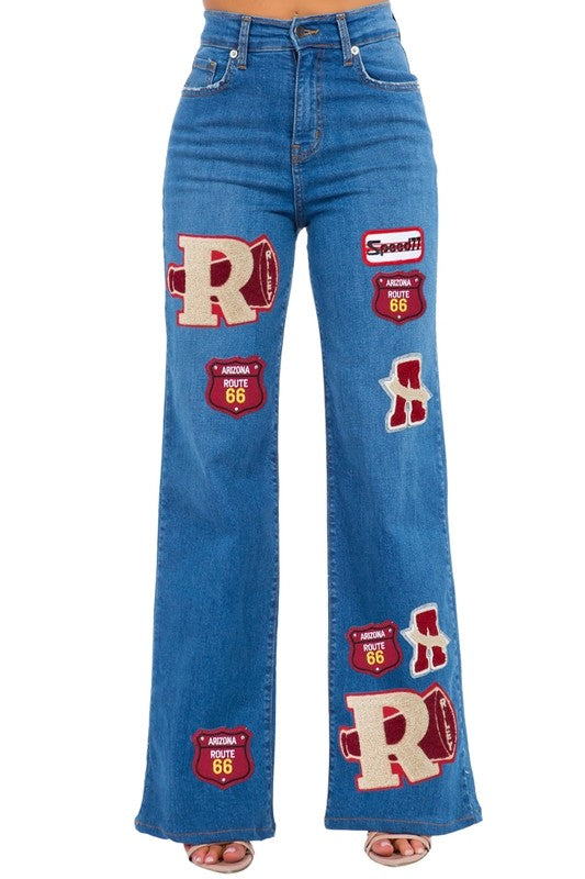 Medium blue varsity wide leg jeans by Jade Icarus, with a relaxed fit and classic denim styling.