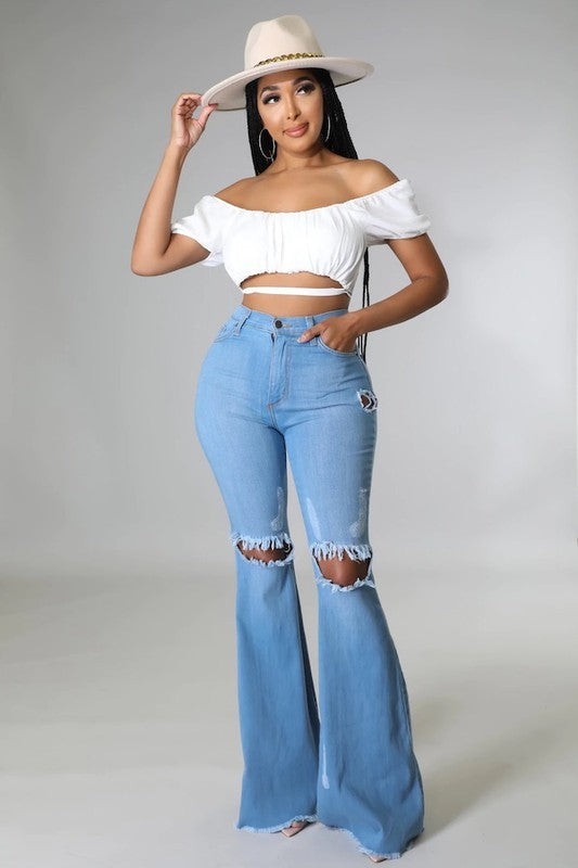 Jade Icarus knee rip flare jeans in medium wash with 32-inch inseam, featuring distressed details and a high-rise fit.