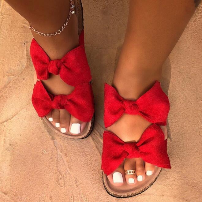 Red women slide sandals with two straps and a bow detail from Silver Juneberry, designed for comfort and casual wear.