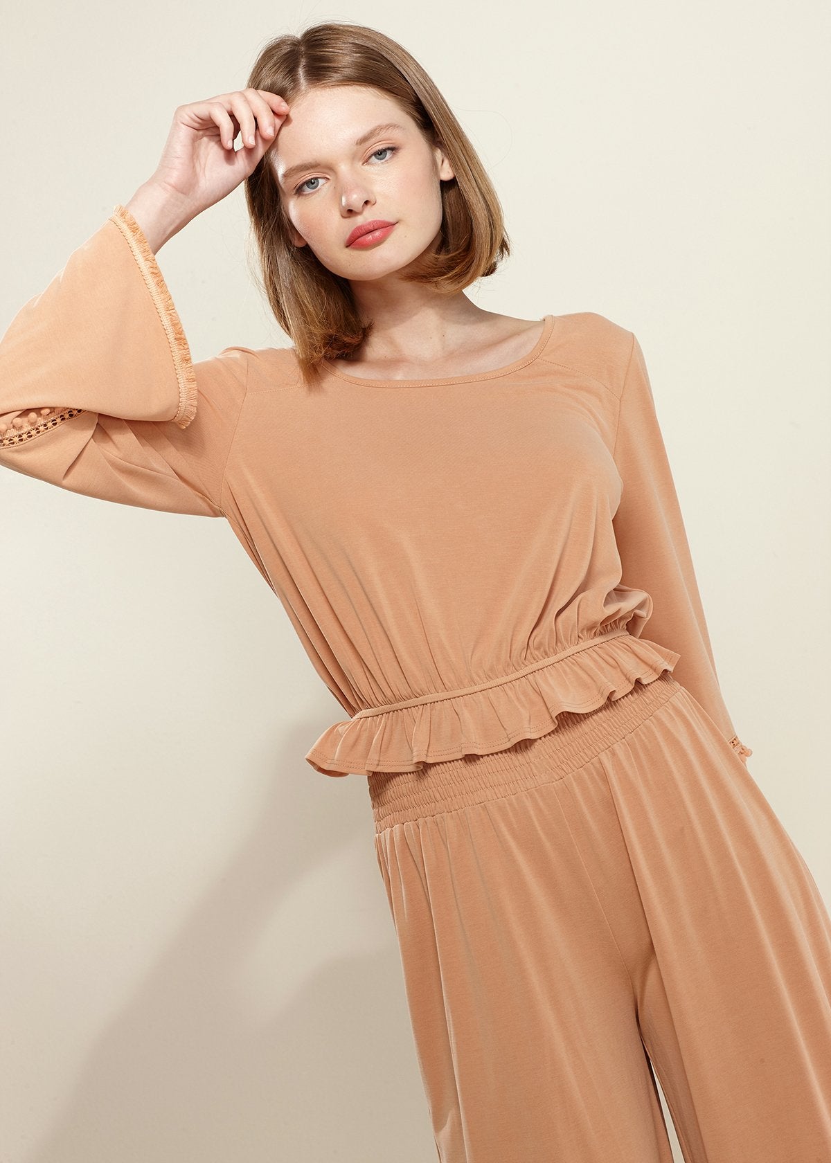 Lemon Hera smocked waist wide-leg palazzo pants in apricot fabric, flowing and stylish for casual or dressy occasions.