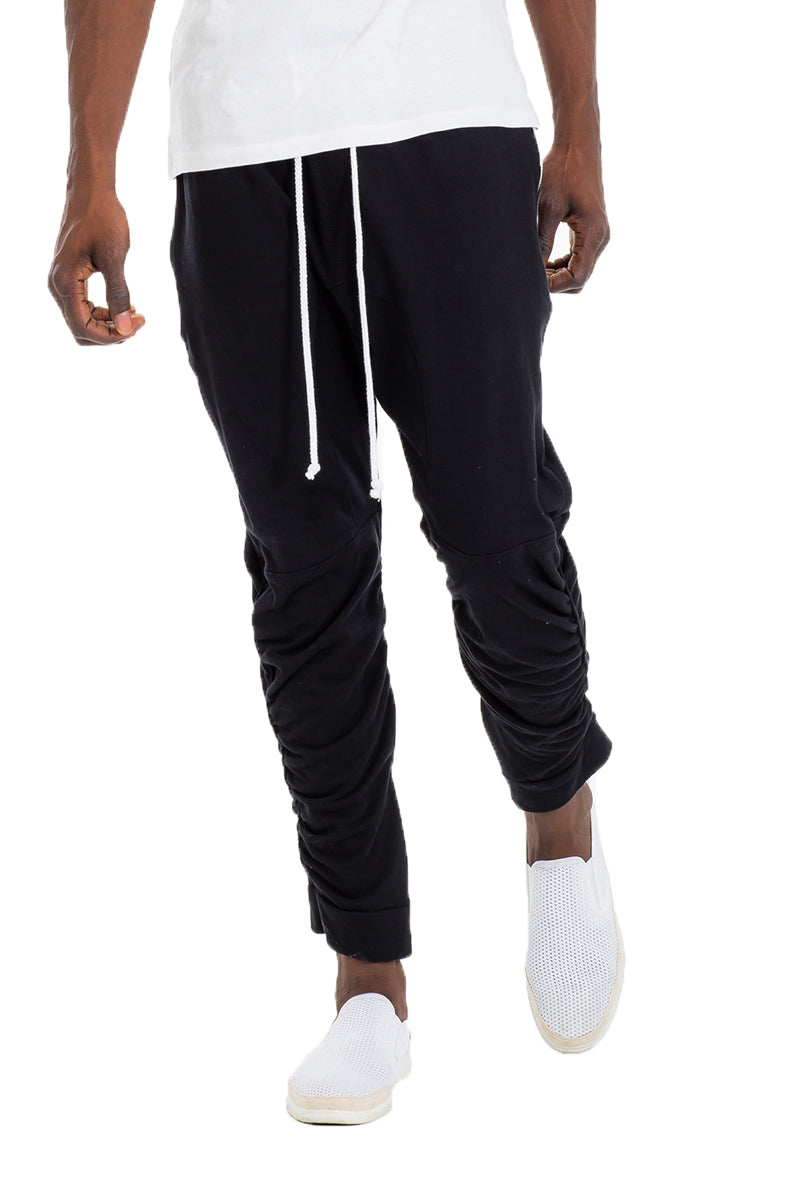 Black gathered cotton sweatpants by Lime Milo, featuring a relaxed fit and soft fabric for comfortable casual wear.