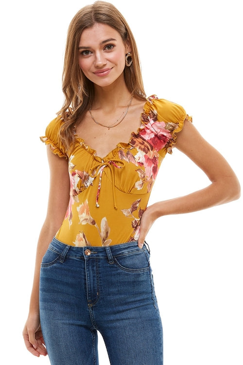 Floral printed peasant style bodysuit for women by Indigo Arrowwood, featuring a relaxed fit and vibrant floral pattern.