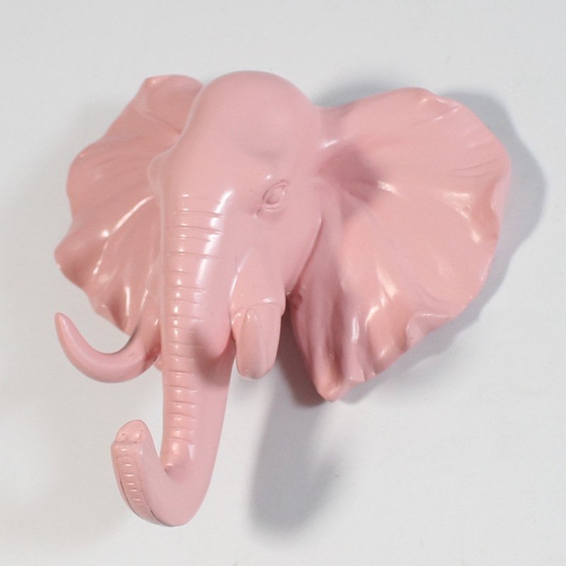 Fuchsia Molly resin elephant head hook mounted on a wall, decorative home & garden accessory with detailed elephant design.