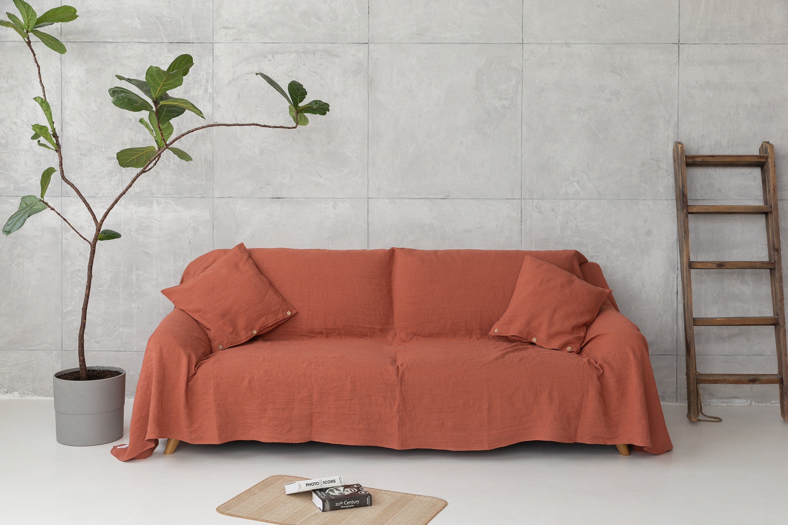 Magenta Sugarplum Woodrose linen couch cover draped over a sofa, showcasing soft, textured home decor fabric.