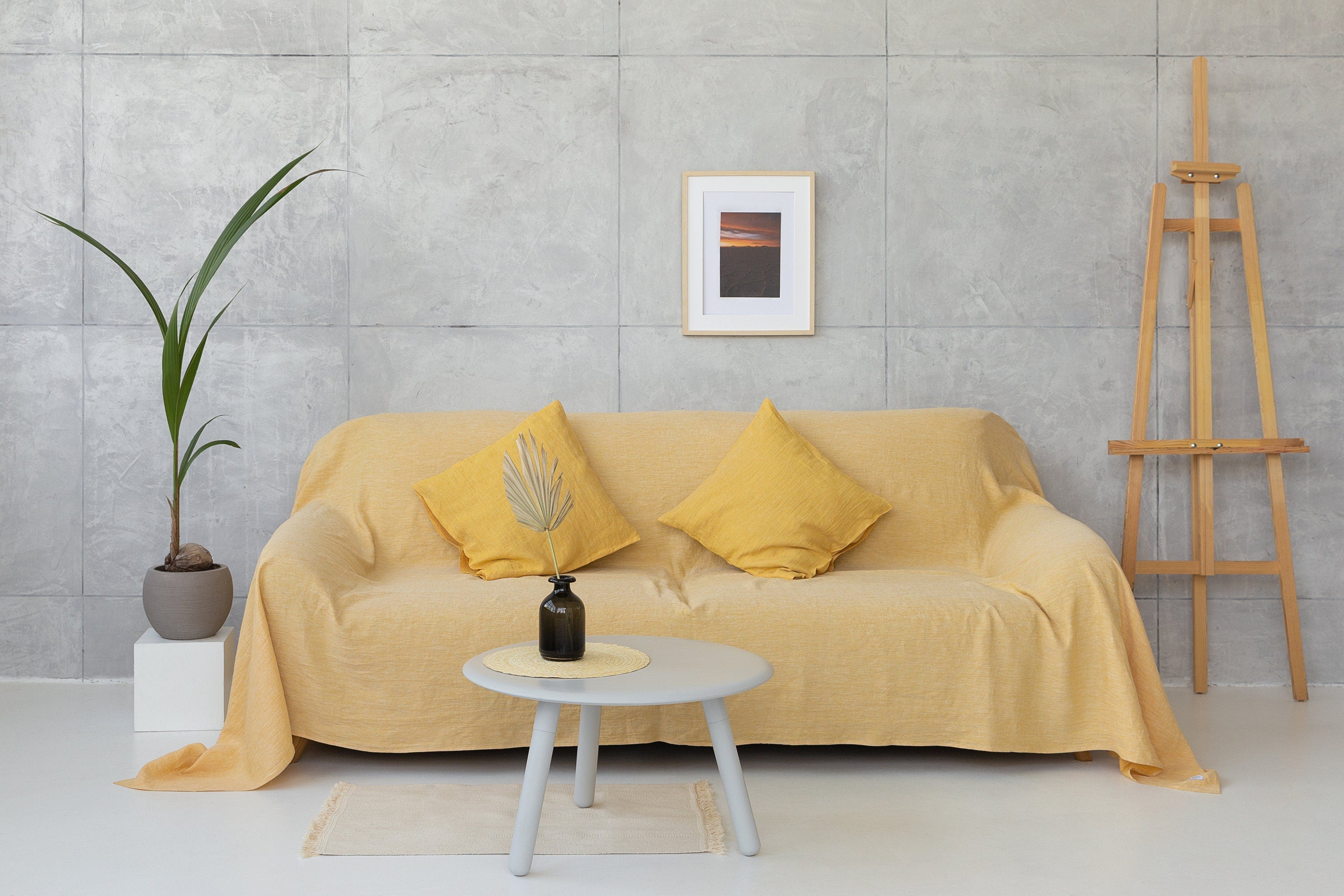 Woodrose linen couch cover by Magenta Sugarplum, soft beige fabric draped over a sofa, enhancing home decor with elegant style.