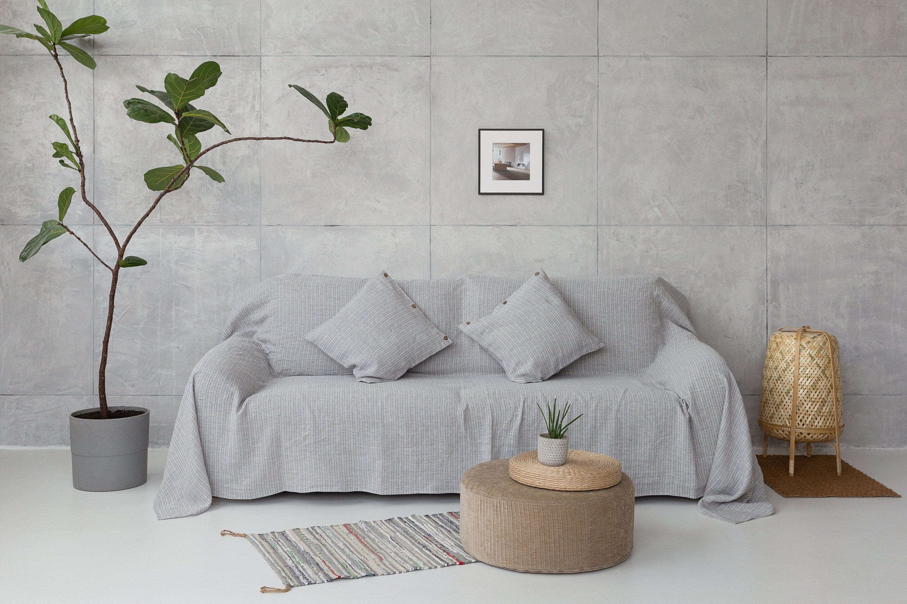 Baby blue linen couch cover by Magenta Sugarplum, showcasing smooth fabric and fitted design on a modern sofa.