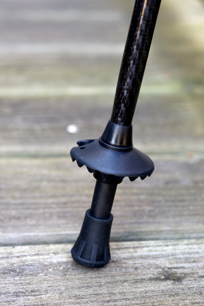 Triangulum trekking poles rubber tips for hiking and camping, 4-pack, with snow and mud terrain on a deck.