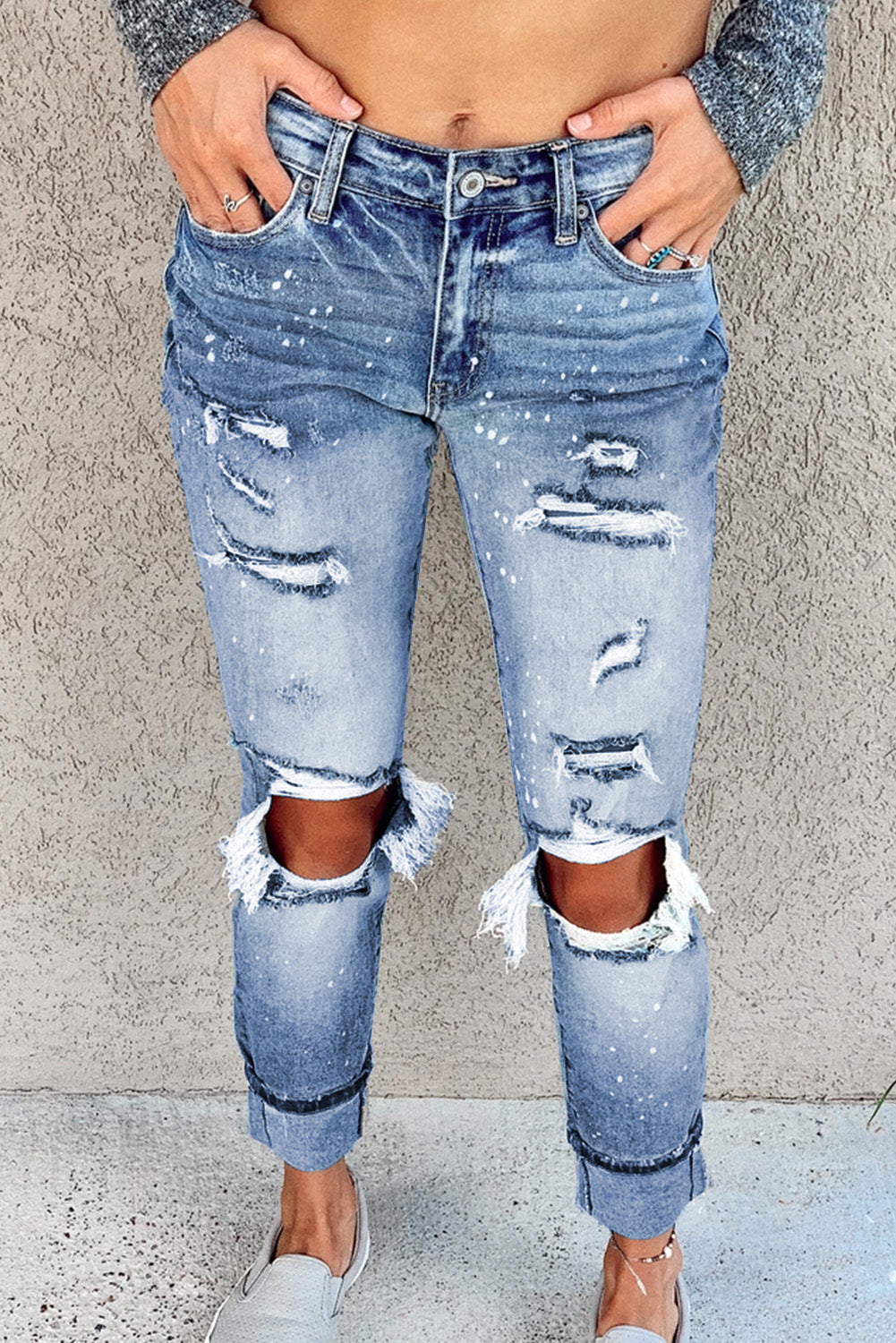 Light blue ripped straight leg jeans for women by Lavender Pallas, featuring distressed details and classic denim fit.