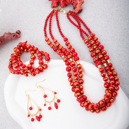 Red Mashan Jade and gold chandelier earrings with intricate design, featuring vibrant red jade stones and elegant gold accents.