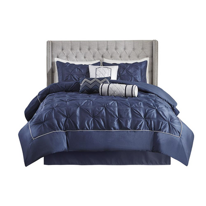 Start2Finish Laurel 7-piece tufted navy comforter set with matching pillow shams and decorative throw pillows on a bed.