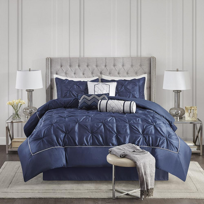 Start2Finish Laurel 7-piece tufted comforter set in navy color, featuring plush fabric and matching pillow shams on a bed.