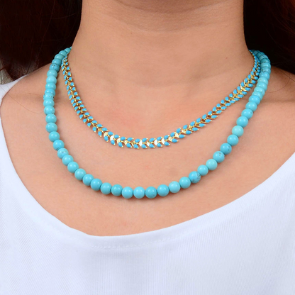 Blue turquoise magnesite layers with golden chevron necklace by Start2Finish, featuring multiple layered stones and a gold-tone chevron pendant.