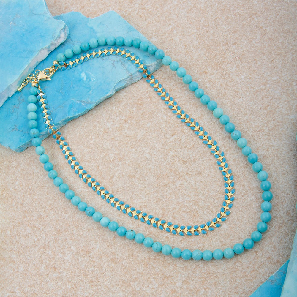 Blue turquoise magnesite layers with a golden chevron pendant on a stylish necklace by Start2Finish.