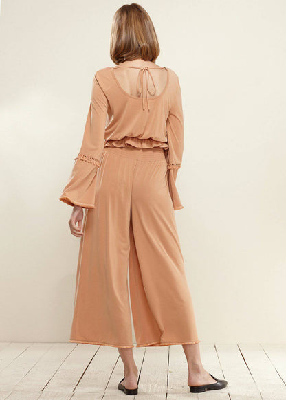 Lemon Hera smocked waist wide-leg palazzo pants in apricot fabric, flowing and stylish for a casual or dressy look.