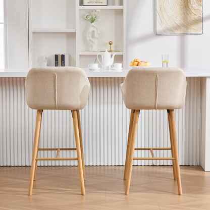 Modern linen upholstered bar stool from Start2Finish with backrest, armrests, footrest, and solid wood legs.