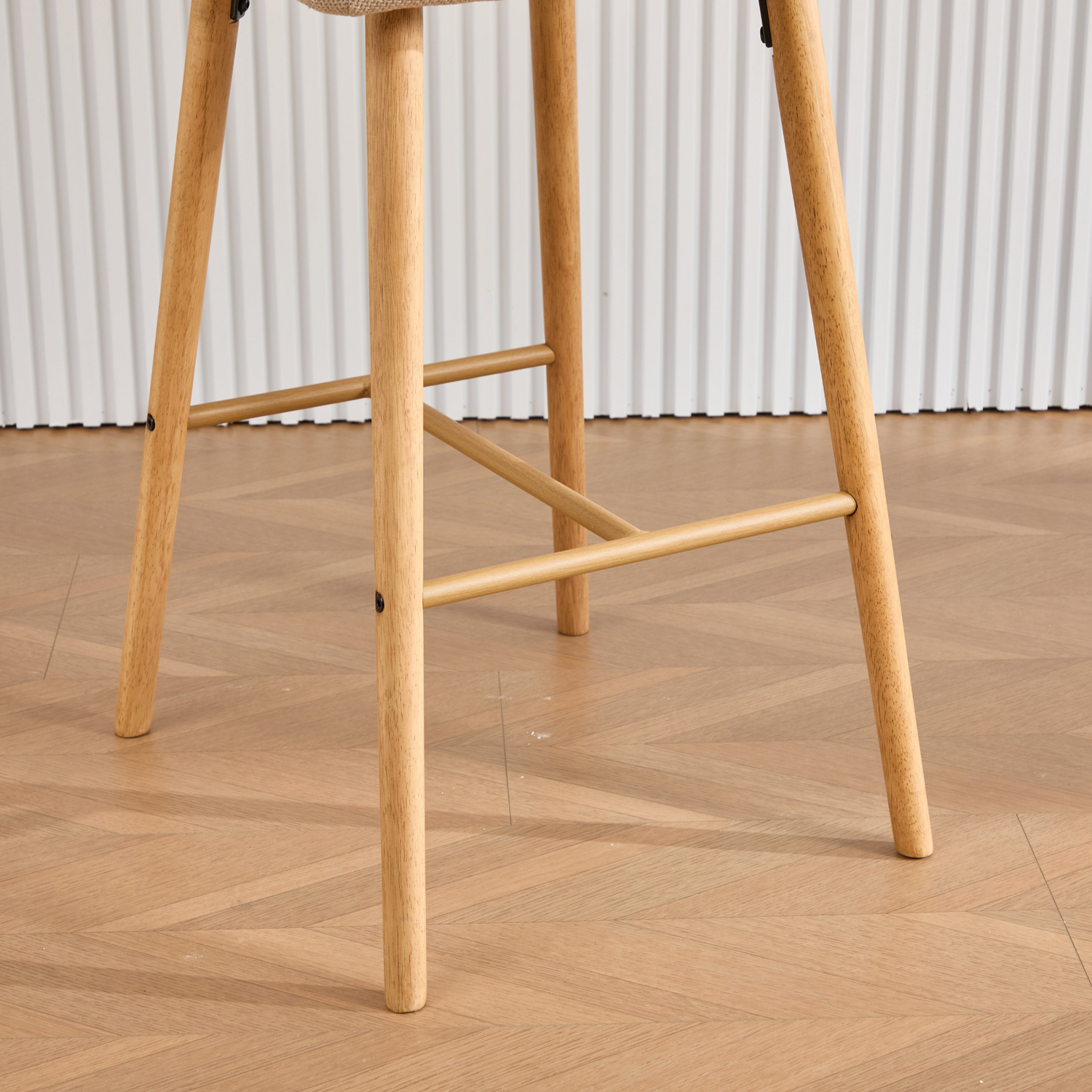 Modern linen upholstered bar stool with back, armrests, footrest, and solid wood legs from Start2Finish.