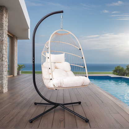Outdoor hanging egg chair with stand, wicker rattan swing with cushion, from Start2Finish, for patio relaxation and outdoor comfort.
