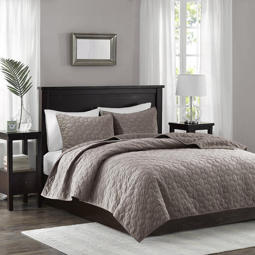 Start2Finish Harper 3-piece velvet quilt set in taupe with matching pillow shams on a bed, showcasing luxurious bedding.