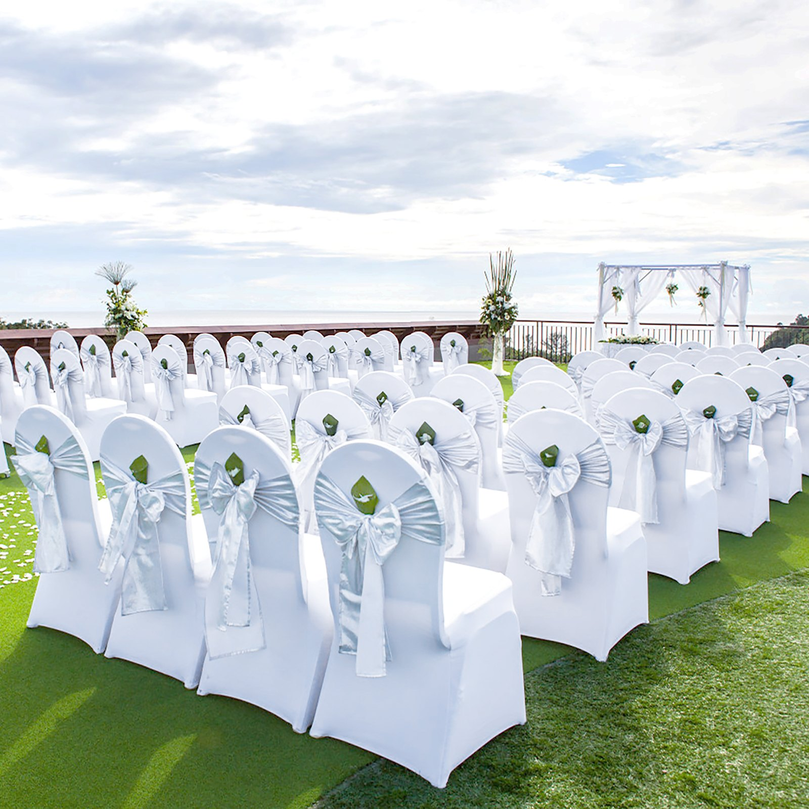 White VEVOR stretch spandex folding chair cover on a chair, demonstrating a fitted, washable protective slipcover for events and parties.