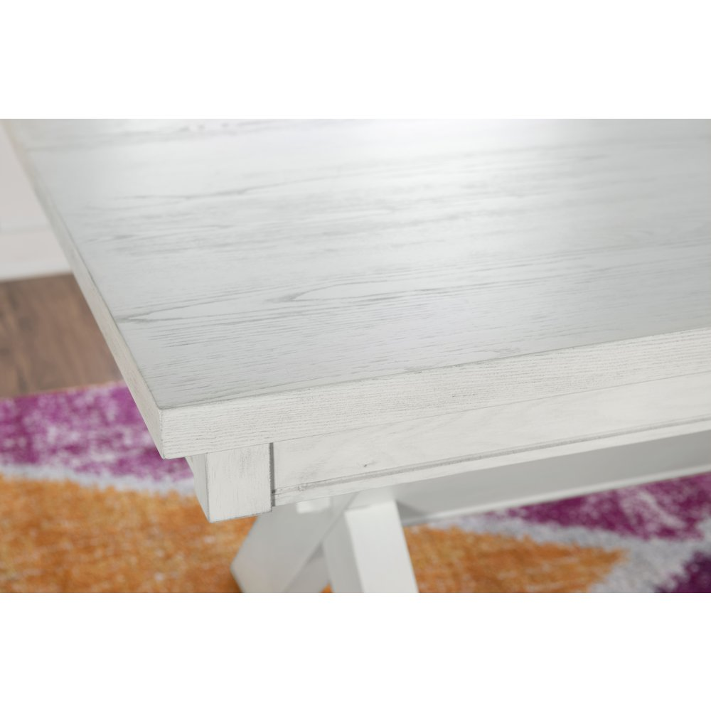 Distressed white Turino dining table by Start2Finish with wooden legs and a rustic finish, shown in a modern dining room setting.