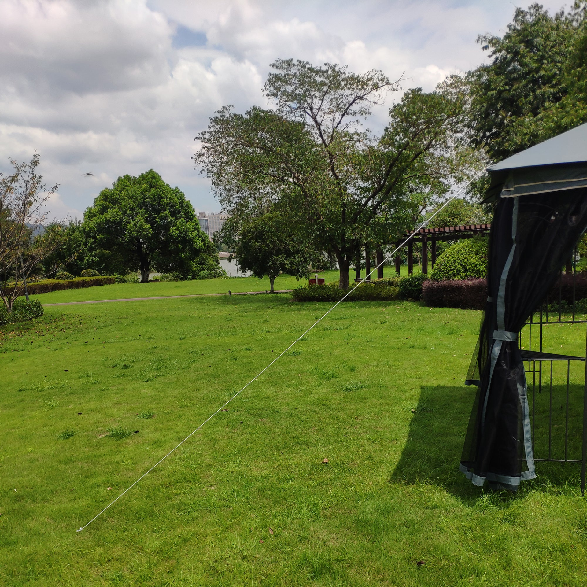 Gray metal outdoor gazebo canopy with roof and storage, ideal for patio and outdoor living spaces by Start2Finish