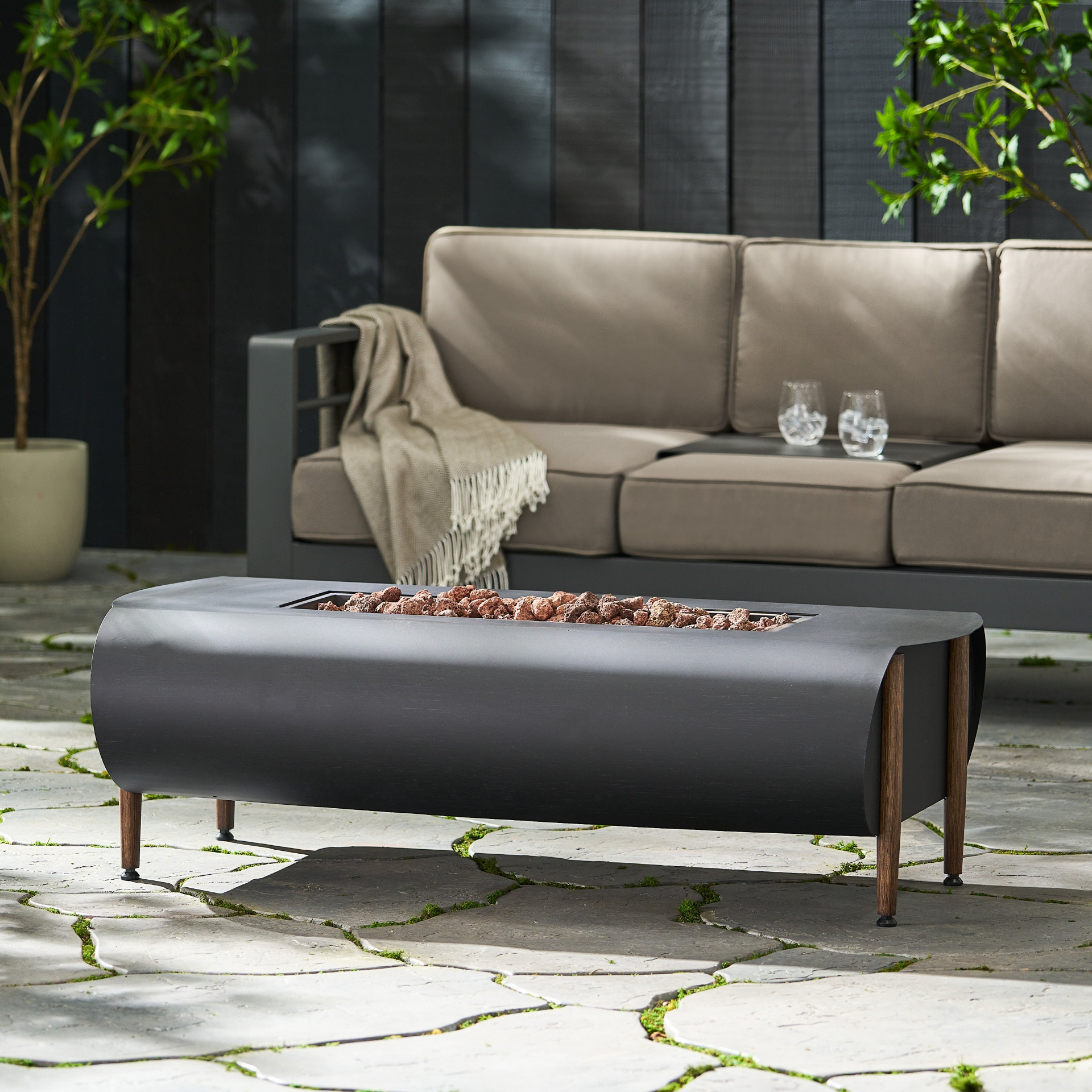 Dark gray iron fire pit table with tank holder for patio and outdoor living by Start2Finish, featuring a sturdy, stylish design.