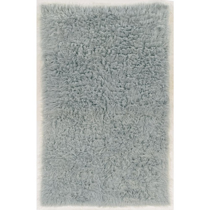 Light grey Flokati rug by Start2Finish, 5x8 feet, plush 1400g wool texture, showcasing soft, thick fibers on a flat surface.