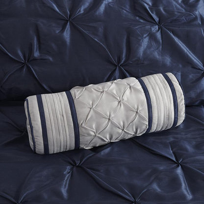 Start2Finish Laurel 7-piece navy tufted comforter set with matching pillow shams and decorative pillows on a bed.