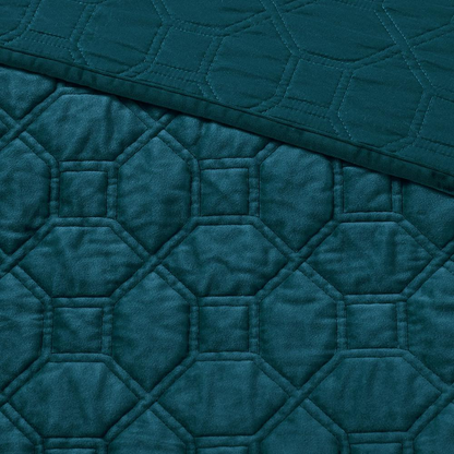 Start2Finish Harper 3-piece velvet quilt set in teal with matching pillow shams on a bed, showcasing luxurious textured fabric.