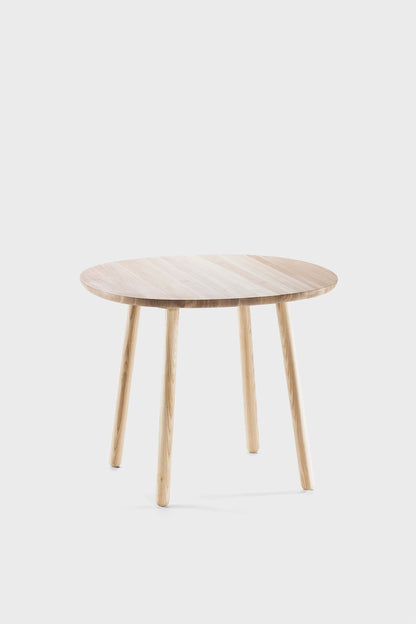Natural wood Naïve dining table by Aquamarine Poppy with a smooth surface and sturdy legs, ideal for modern dining rooms.