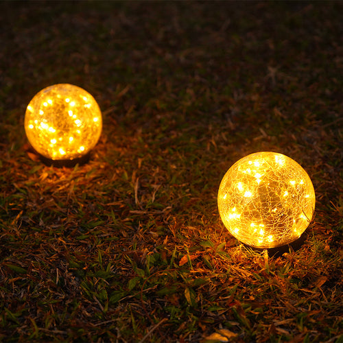 Pink Iolaus outdoor solar crack bottle 20-light waterproof decorative lighting displayed outdoors in a garden setting.