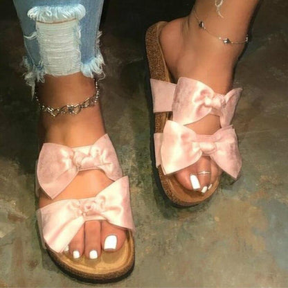 Pink Silver Juneberry women’s slide sandals with two straps and bow detail, featuring a comfortable, casual design.
