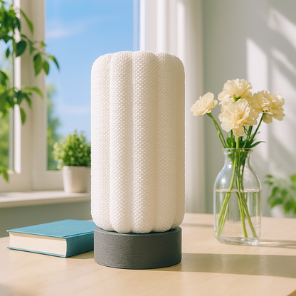 Azure Pontus Lumacore table lamp with sleek modern design and illuminated white shade on a wooden surface.