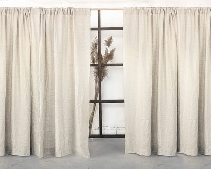 Grey linen curtain with rod pocket from Magenta Sugarplum, showcasing a soft, textured fabric hanging on a curtain rod.