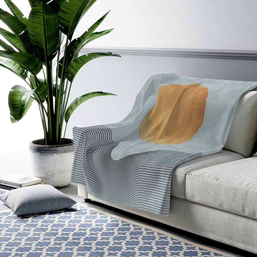 Blue plush throw blanket with abstract sun art design from Yellow Pandora, available in three sizes for home decor.