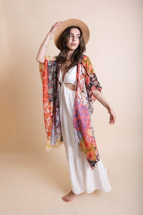 Colorful boho patchwork kimono by Periwinkle Aether featuring layered fabric and intricate patchwork in shades of blue.