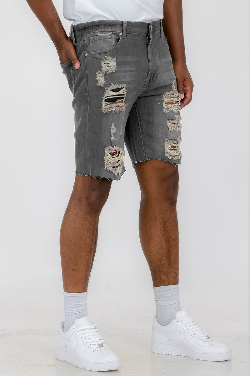 Mens distressed denim shorts by Lime Milo, showing rugged, faded blue denim with frayed hem and distressed details.