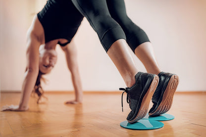 Black Lavender core and abs exercise sliders on a smooth surface, used for fitness and core strengthening workouts.