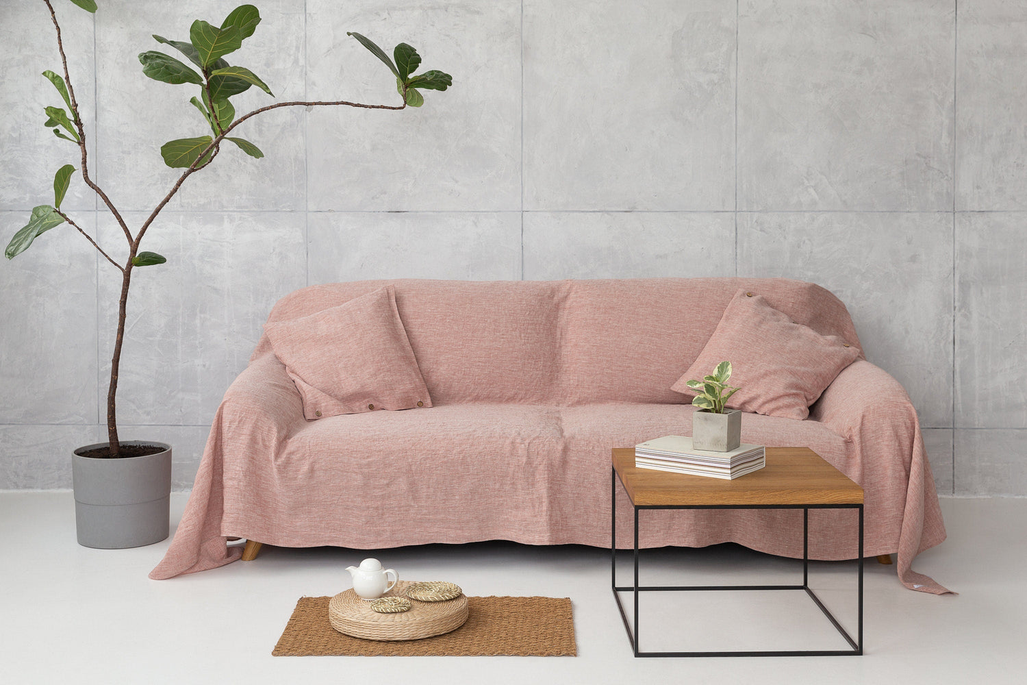 Magenta Sugarplum Woodrose linen couch cover draped over a sofa, showcasing textured fabric and elegant home decor style.