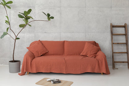 Reddish brown linen couch cover by Magenta Sugarplum, stylish home decor fabric draped over a sofa.