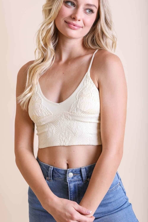 Seamless ivory stretchable brami top from Periwinkle Aether, textured fabric, padded for comfort, ideal for active lifestyles.